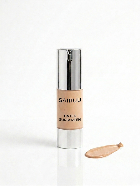 SAIRUU Tinted Sunscreen bottle with a silver cap and a beige tinted liquid swatch on a white background.